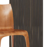 Vertical Wall panel in the color bronze noir with chair in front of it for scale